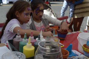 Young attendees paint flower pots at Bronx Summer Fest 2016.